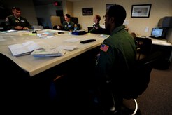 Staff Sgt. Kevin Sumlin attends a crew brief before a mission at Joint Base Charleston, Nov. 2.  The Flying Crew Chiefs Office is a special duty assignment designed to provide a flying mission with a single-person maintenance package.  Sumlin is a flying crew chief with the 437th Aircraft Maintenance Squadron.  (U.S. Air Force photo/ Staff Sgt. Nicole Mickle)  