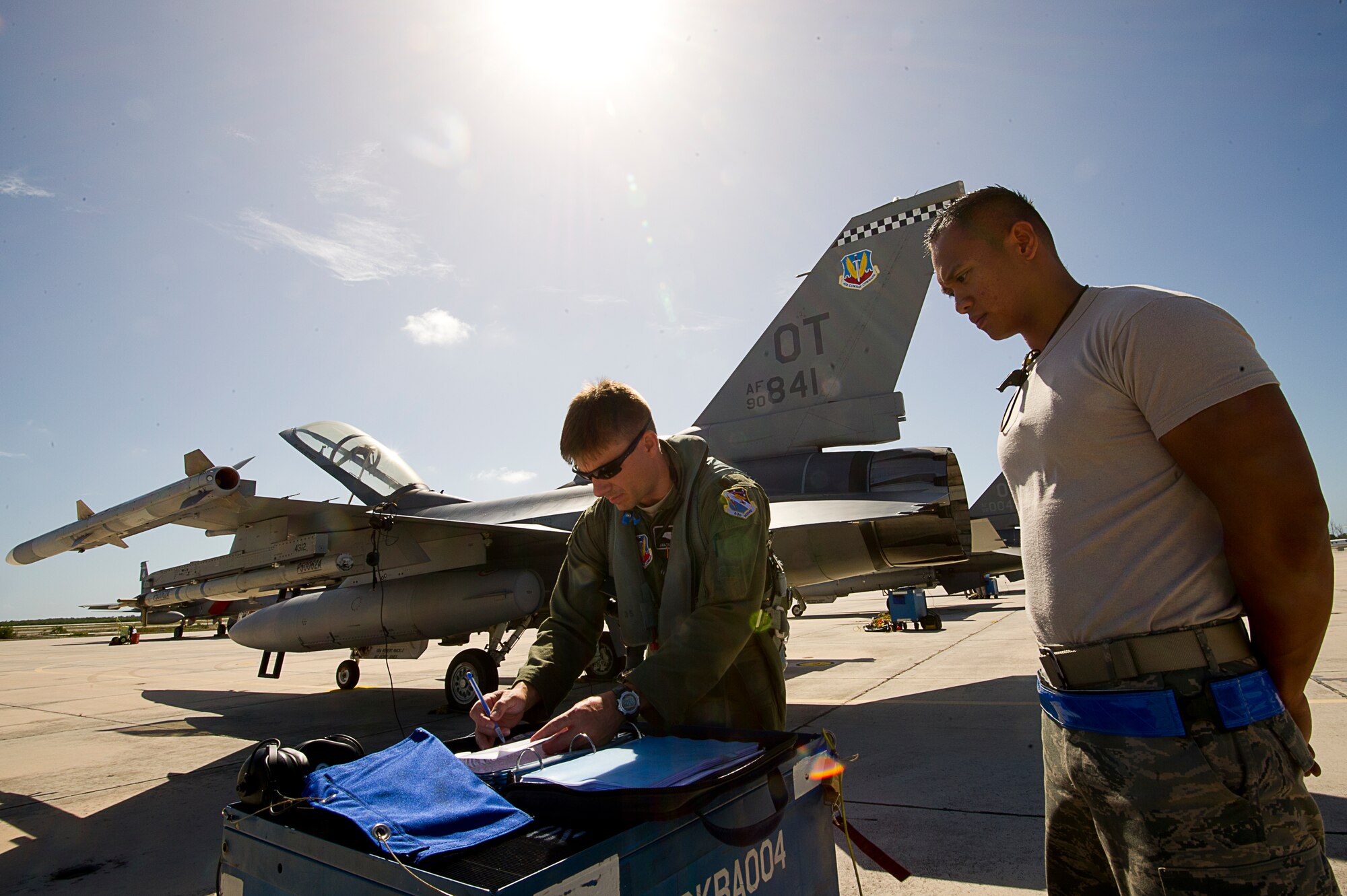 NAVAL AIR STATION KEY WEST, Fla. - Air Force Staff Sgt. Jam Baro, crew chief, from the 46th Aircraft Maintenance Squadron, blue aircraft maintenance unit, Eglin Air Force Base, Fla., and Air Force Maj. James Geoppinger review all paperwork before a mission during exercise Vigilant Shield 12 on Naval Air Station Key West, Fla., Nov. 6. The exercise in Key West will be the "first-ever proof of concept" for the military's Joint Deployable Integrated Air and Missile Defense System, a collection of high-end radars and missile systems as well as aircraft that work in tandem in the event of a threat to the continental United States. (U.S. Air Force photo by Tech. Sgt. Dennis J. Henry Jr.)