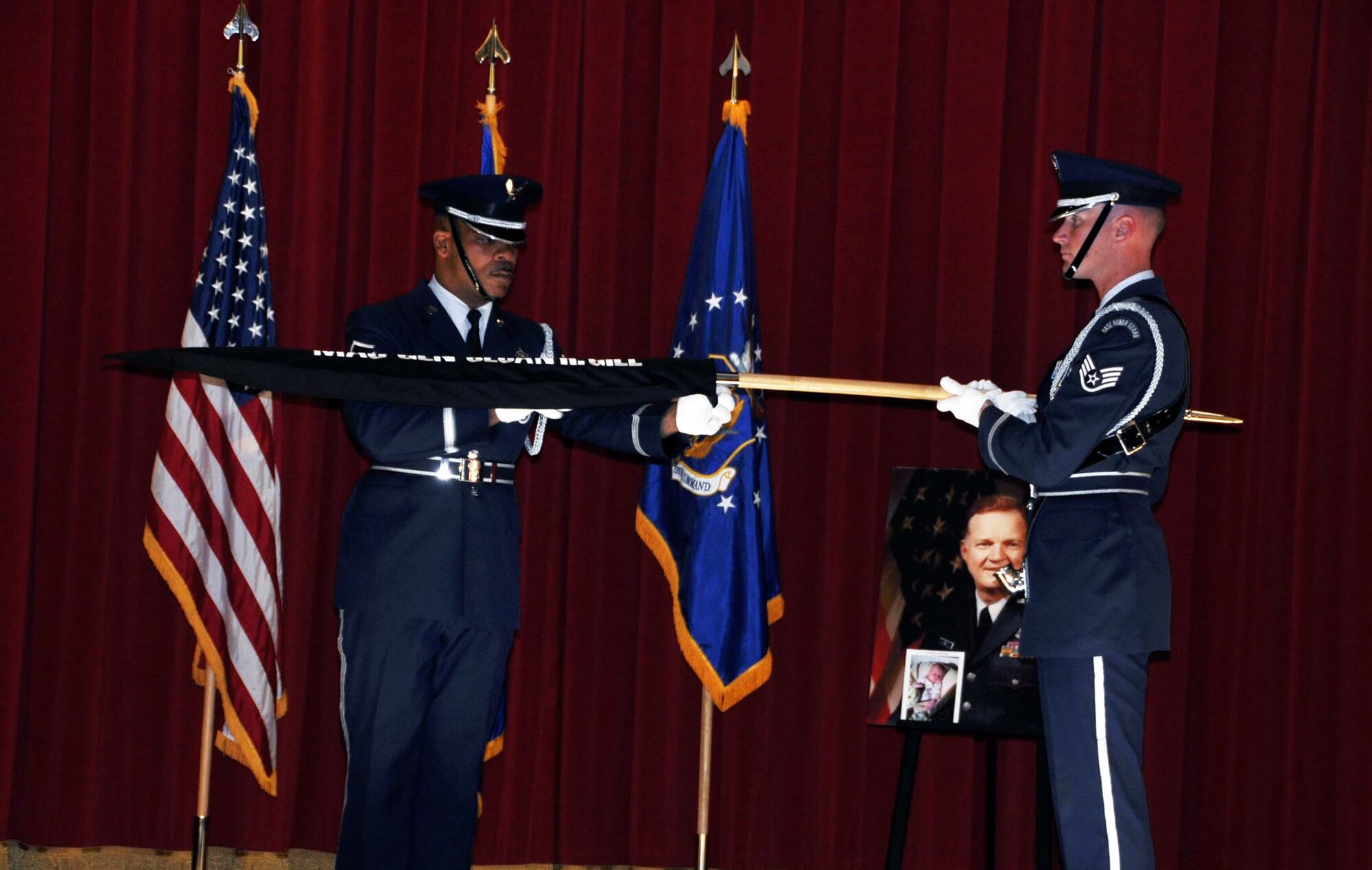 Master Sgt. Darryl Willingham, 452nd Mission Support Group and Staff Sgt. Paul Connors, 95th Force Support Squadron and both members of the Blue Eagle’s Total Force Honor Guard, encase the personal colors of retired Maj. Gen. Sloan R. Gill for the last time at the general's memorial service held at March Air Reserve Base, Calif. Nov 6, 2011.  Gill was a former chief of the Air Force Reserve and former commander of Air Force Reserve Command.  (U.S. Air Force photo/Master Sgt. Linda Welz)