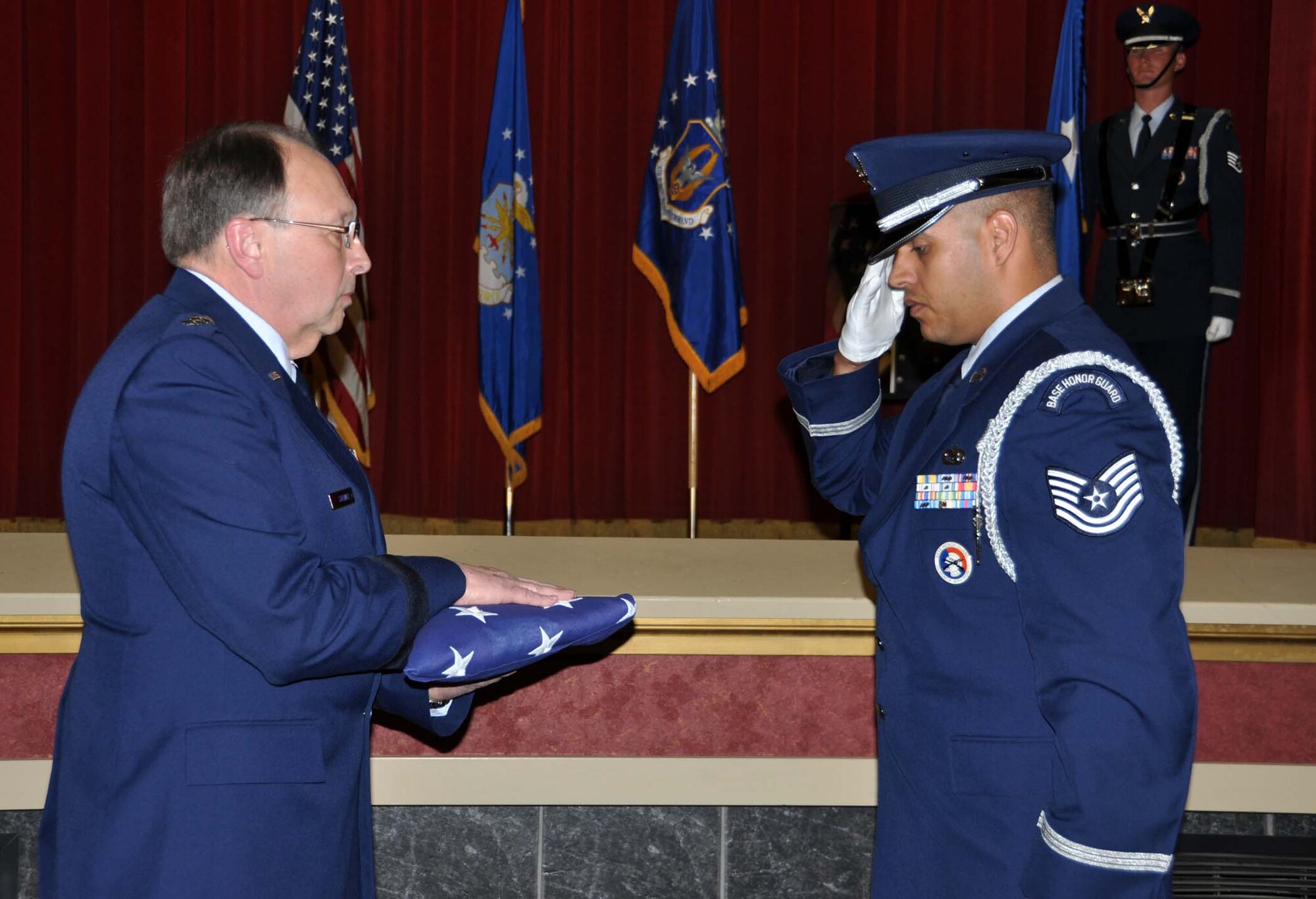 Tech. Sgt. Dana Mikles, 452nd Maintenance Squadron and Blue Eagle’s Total Force Honor Guard member, renders a salute to the flag he gave to Lt. Gen. Charles Stenner, chief, Air Force Reserve and commander, Air Force Reserve Command, at the Nov. 6 memorial service held at March Air Reserve Base, Calif. for retired Maj. Gen. Sloan R. Gill, former AFRC commander, who passed away Aug. 22, 2011.  Stenner presented the folded flad to Gill's daughter, Roxann.  (U.S. Air Force photo/Master Sgt. Linda Welz)
