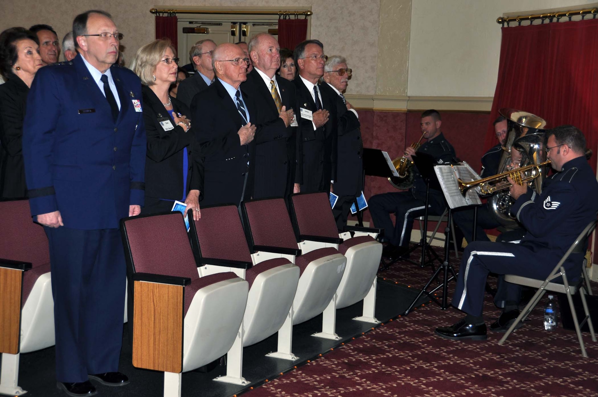Lt. Gen. Charles Stenner, Chief of Air Force Reserve and Commander, Air Force Reserve Command stands at attention as his wife, Dee, retired Gen. James P. Mullins, retired Lt. Gen. James Sherrard, retired Lt. Gen John Bradley and retired Maj. Gen. Homer Lewis hold their hands over their hearts during a Nov. 6 memorial service held at March Air Reserve Base, Calif., for former AFRC commander Maj. Gen. Sloan R. Gill.  The memorial was attended by six former AFRC commanders.  (U.S. Air Force photo/Master Sgt. Linda Welz