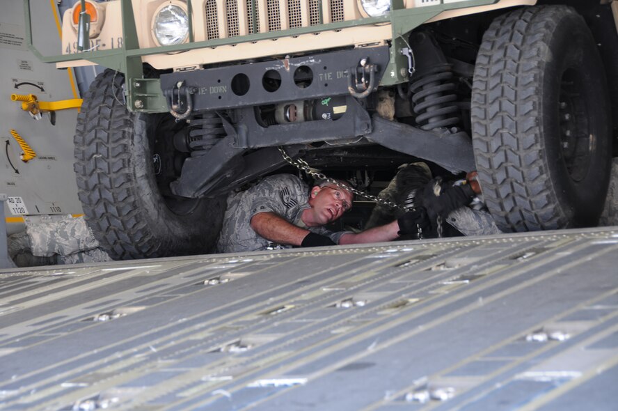 Tech. Sgt. Matthew Haefemeyer, 161 Air Refueling Wing Aerial Port, secures a humvee on a C-17 Globemaster III in support of Vigilant Guard, Nov. 6, 2011 in Phoenix. Vigilant Guard is an exercise involving the nation's first responders, whose mission was to respond to a simulated flood and improvised nuclear device detonation during the exercise here, Nov. 2-7, 2011. Members from the 161 ARW, along with National Guard units from California, Colorado, and Arizona, along with local, state and federal emergency responders participated in the exercise. (U.S. Air Force photo/Master Sergeant Kelly M. Deitloff)
