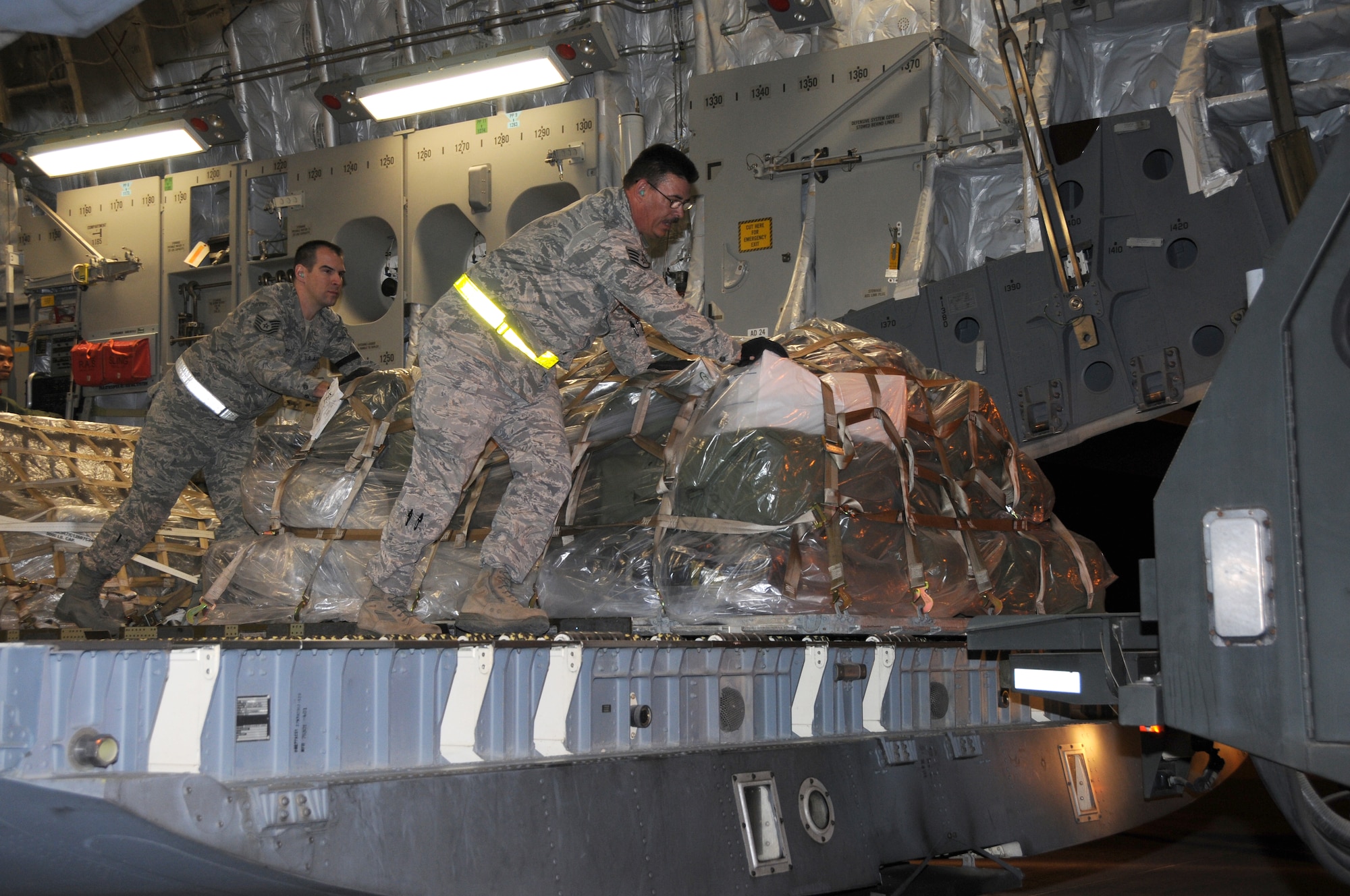 Tech. Sgt. Zack Davenport and Staff Sgt. Bret Earls, 161 Air Refueling Wing Aerial Port, unload a pallet off a C-17 Globemaster III in support of Vigilant Guard, Nov. 2, 2011 in Phoenix. Vigilant Guard is an exercise involving the nation's first responders, whose mission was to respond to a simulated flood and improvised nuclear device detonation during the exercise here, Nov. 2-7, 2011.Members from the 161 ARW, along with National Guard units from California, Colorado, and Arizona, along with local, state and federal emergency responders participated in the exercise. (U.S. Air Force photo/Master Sergeant Kelly M. Deitloff)

