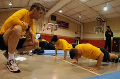 Captain Ralph Ward counts push-ups for Lt. j.g. John Quay during the Naval Support Activity Charleston’s Physical Readiness Test at Joint Base Charleston-Weapons Station Nov. 3.  The PRT, conducted twice a year, consists of a cardiovascular test, push-ups and sit-ups and tests each Sailor’s cardio-respiratory endurance, muscular strength and stamina performance.  Ward is the Joint Base Charleston deputy commander and Quay is a Chaplain assisgned to Joint Base Charleston.  (U.S. Navy photo/Petty Officer 3rd Classs Brannon Deugan)