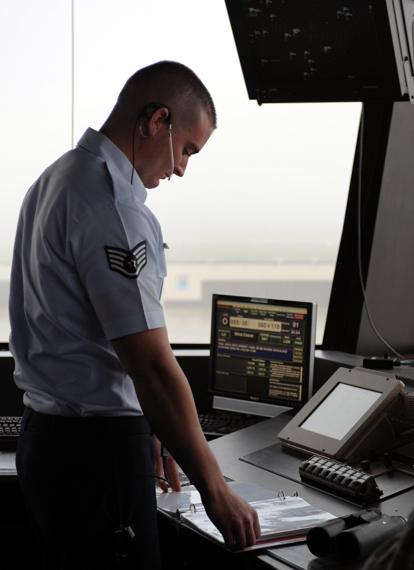 WHITEMAN AIR FORCE BASE, Mo -- Staff Sergeant John Roberts, 509th Operations Support Squadron air traffic controller, monitors aircraft taking off and taxiing Nov. 7. Air traffic controllers clear airspace prior to aircraft taking off, transitioning into Whiteman AFB airspace, and landing to ensure aircraft launch, fly and land safely. (U.S. Air Force photo/Senior Airman Laura Goodgame) 