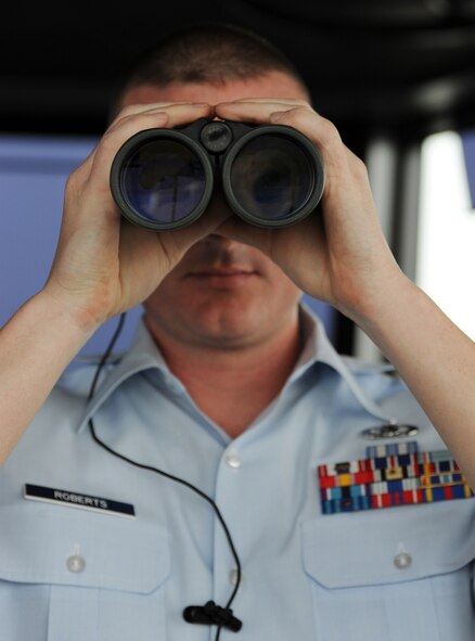 WHITEMAN AIR FORCE BASE, Mo -- Staff Sergeant John Roberts, 509th Operations Support Squadron air traffic controller, watches for approaching aircraft from the control tower Nov. 7. Roberts is able to communicate with the aircraft as a second set of eyes for the pilots to ensure maximum flight line safety. (U.S. Air Force photo/Senior Airman Laura Goodgame) 