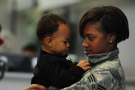 Jayden Nanton reunites with his mother, Senior Airman Lauren Craig, after she returned from an 120- day deployment to Southwest Asia, Nov. 5 at Joint Base Charleston - Air Base.  More than 130 Airmen from the 14th Airlift Squadron, 437th Airlift Wing were assigned to the 816th Expeditionary Airlift Squadron, supporting combat operations in the U.S. Central Command area of responsibility. Flying the C-17 Globemaster III, the 14 AS Airmen flew roughly 2,800 sorties, logged more than 7,900 combat flying hours and airlifted more than 27,000 Airmen, Soldiers, Marines and distinguished visitors throughout the AOR. The squadron also performed 382 airdrops, delivering 16.7 million pounds of cargo to 52 drop zones, breaking the record for deployed C-17 combat operations.  Diaz is with the 437th Operations Support Squadron.  (U.S. Air Force photo/ Staff Sgt. Nicole Mickle 
