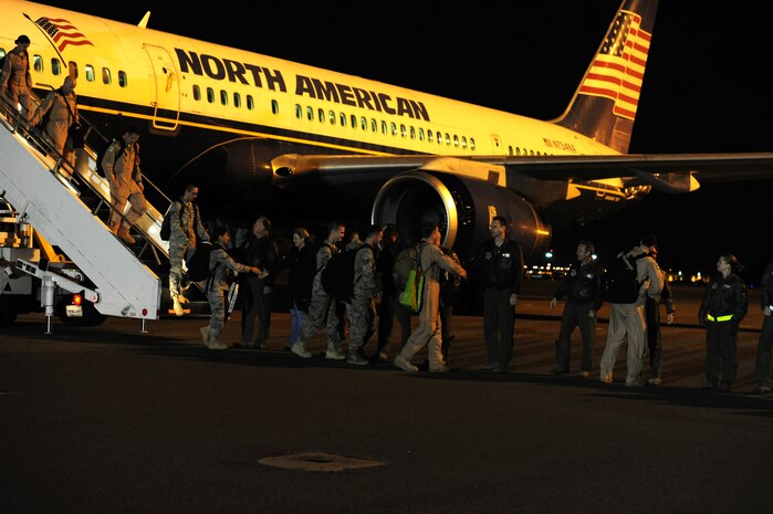 Airmen from the 14th Airlift Squadron, 437th Airlift Wing, are greeted after returning from a 120- day deployment to Southwest Asia,  Nov. 5 at Joint Base Charleston - Air Base.  More than 130 Airmen from the 14 AS were assigned to the 816th Expeditionary Airlift Squadron, supporting combat operations in the U.S. Central Command area of responsibility. Flying the C-17 Globemaster III, the 14 AS Airmen flew roughly 2,800 sorties, logged more than 7,900 combat flying hours and airlifted more than 27,000 Airmen, Soldiers, Marines and distinguished visitors throughout the AOR. The squadron also performed 382 airdrops, delivering 16.7 million pounds of cargo to 52 drop zones, breaking the record for deployed C-17 combat operations.  Diaz is with the 437th Operations Support Squadron.  (U.S. Air Force photo/ Staff Sgt. Nicole Mickle) 
 
