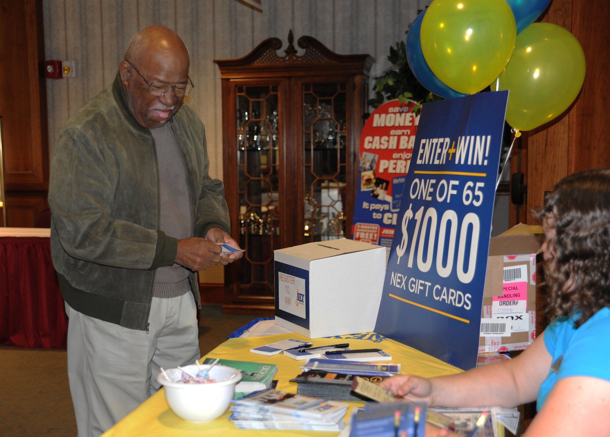 Charles Aiken enters a contest to win a $1,000 gift card to the Navy Exchange at the Retiree and Souse Information Fair held at the Charleston Club on Joint Base Charleston Nov. 5. The fair was held to inform retirees about their benefits and services available on JB Charleston. Aiken is a retired Air Force senior master sergeant. (U.S. Air Force photo/Airman 1st Class Ashley Galloway)
