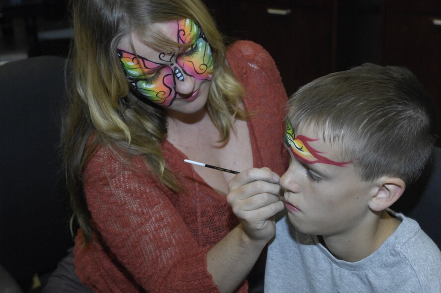 Liam Sather,10, has his face painted by Dianne Nowicki during Hallelujah Night at Luke Air Force Base, Ariz., Oct 28, 2011. Games, food and live entertainment were provided to all participants of this annual event held by the Luke Chapel. (U.S. Air Force photo by Staff Sgt. Jason Colbert/Released)
