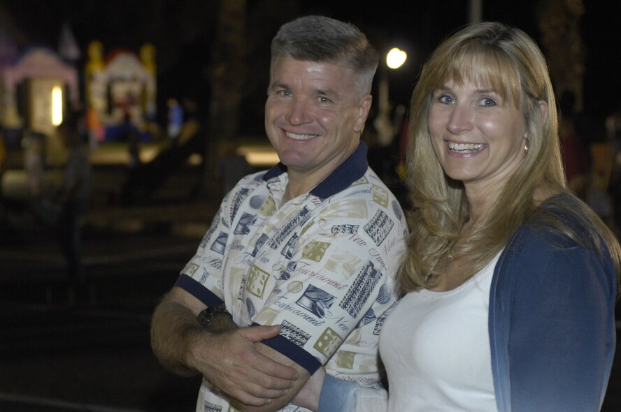 Brig. Gen. JD Harris and Heather Harris smile after the opening ceremonies during Hallelujah Night at Luke Air Force Base, Ariz., Oct 28, 2011. There was live singing, McGruff the crime dog and many other games for children and families alike.  (U.S. Air Force photo by Staff Sgt. Jason Colbert/Released)
