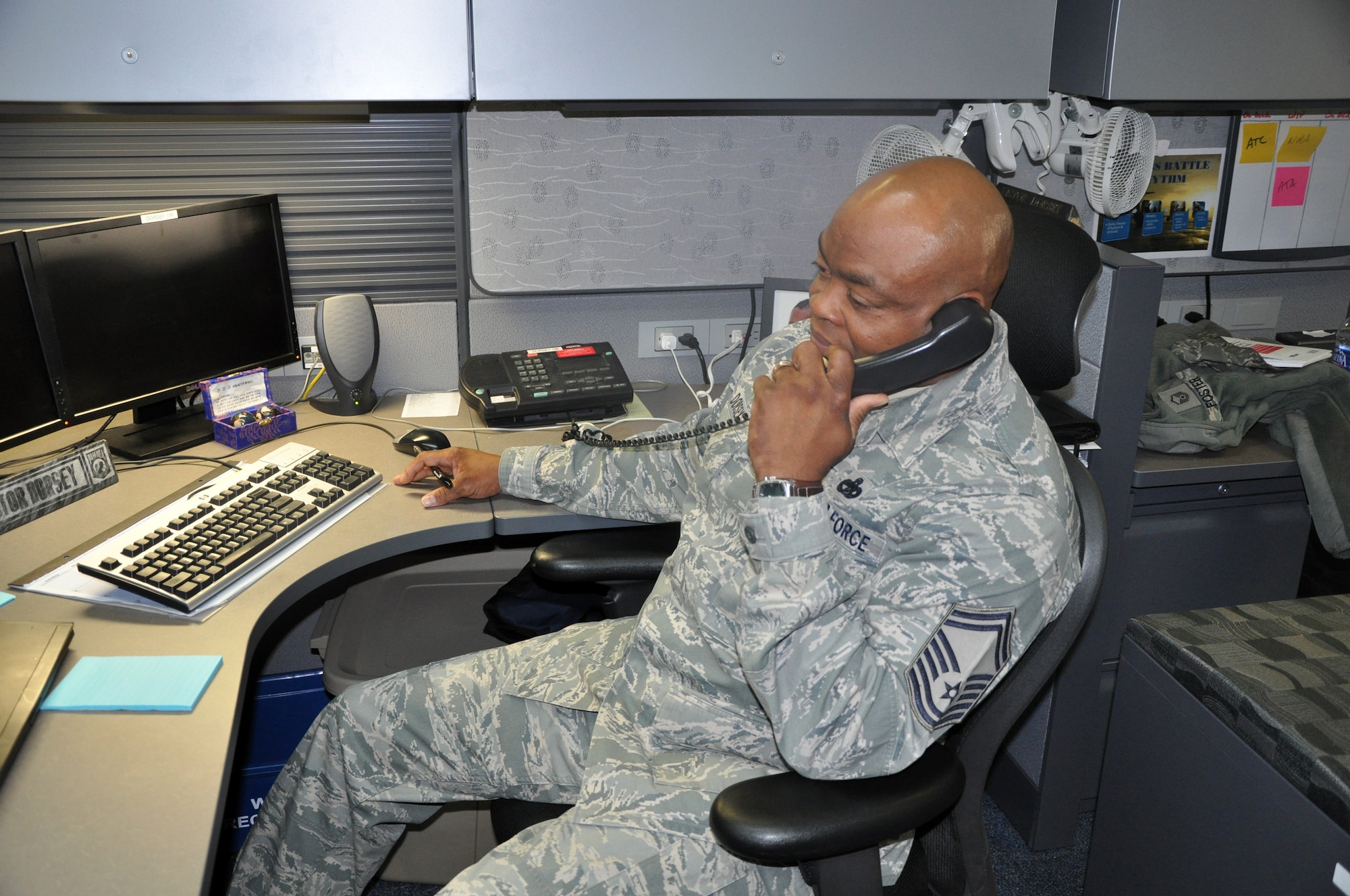 Senior Master Sgt. Victor Dorsey works in his office at Headquarters Air Mobility Command at Scott Air Force Base, Ill., on Oct. 21, 2011. Dorsey and his family have been active participants in supporting the Make A Wish Foundation for more than 10 years. (U.S. Air Force Photo/Master Sgt. Sabrina D. Foster)