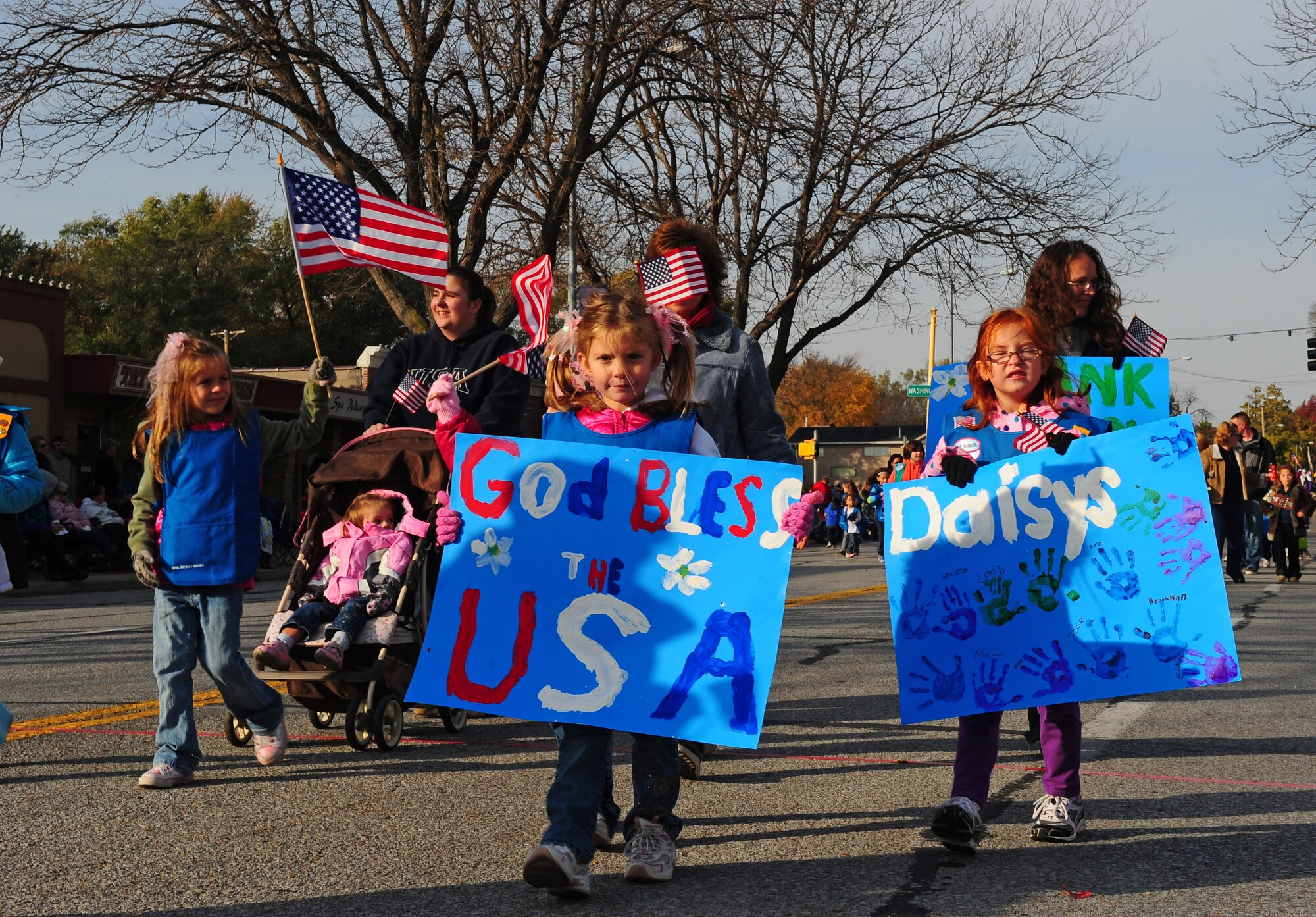 The Daisy Scouts march down Mission Avenue in Bellevue, Neb.,  while participating in the 2011 Veterans Day Parade, Nov. 5.  Scouts of all ages participated in marching alongside military members during the annual parade. (U.S. Air Force photo by Josh Plueger/Released)
