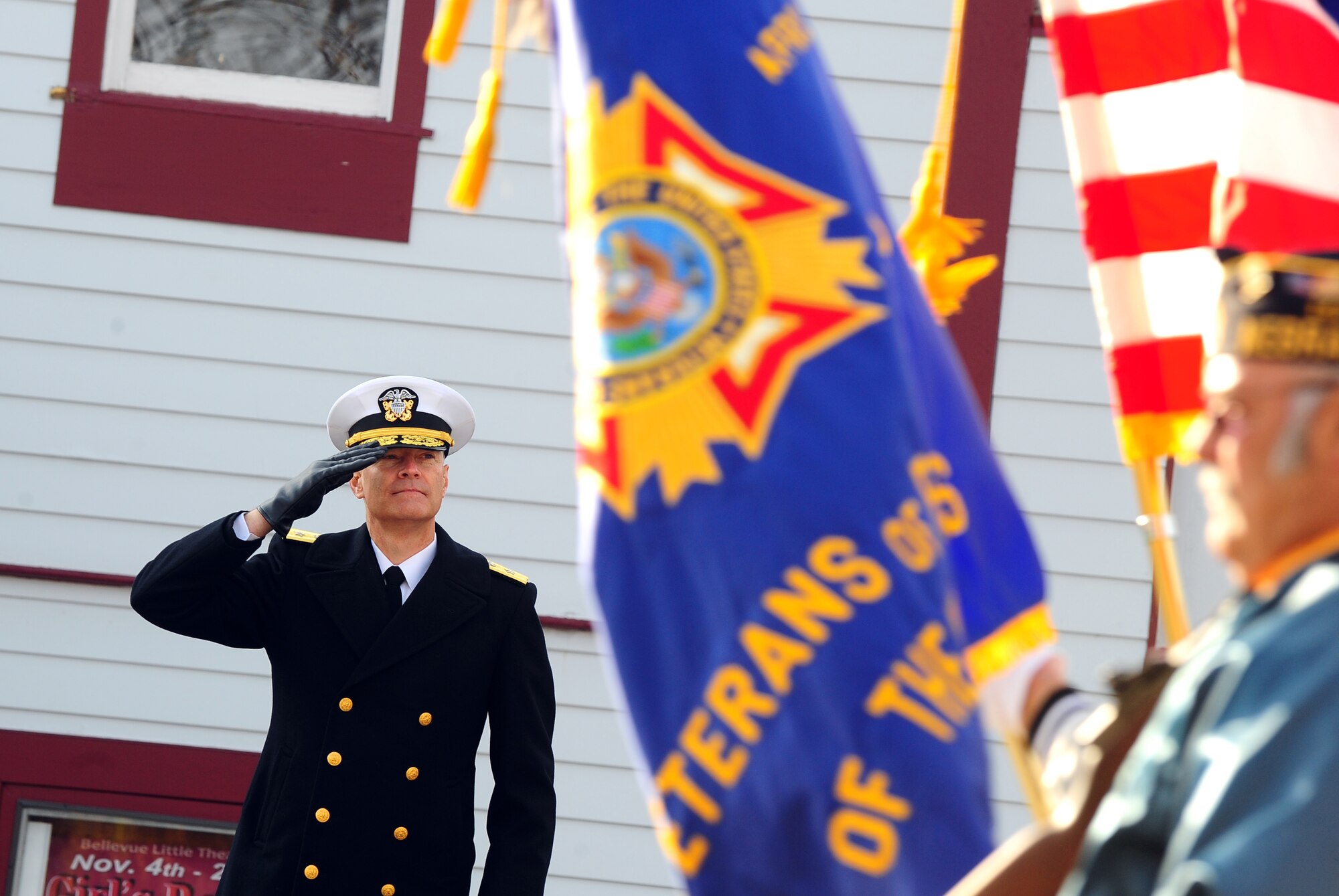 U.S. Navy Rear Adm. Fritz Roegge, Joint Functional Component Command for Global Strike at U.S. Strategic Command, salutes the colors as they pass the grand stand during the annual Veterans Day parade held in Bellevue, Neb., Nov.5 .  All branches of the armed forces along with local area residents lined the streets to pay tribute to those who serve. (U.S. Air Force photo by Josh Plueger/Released)