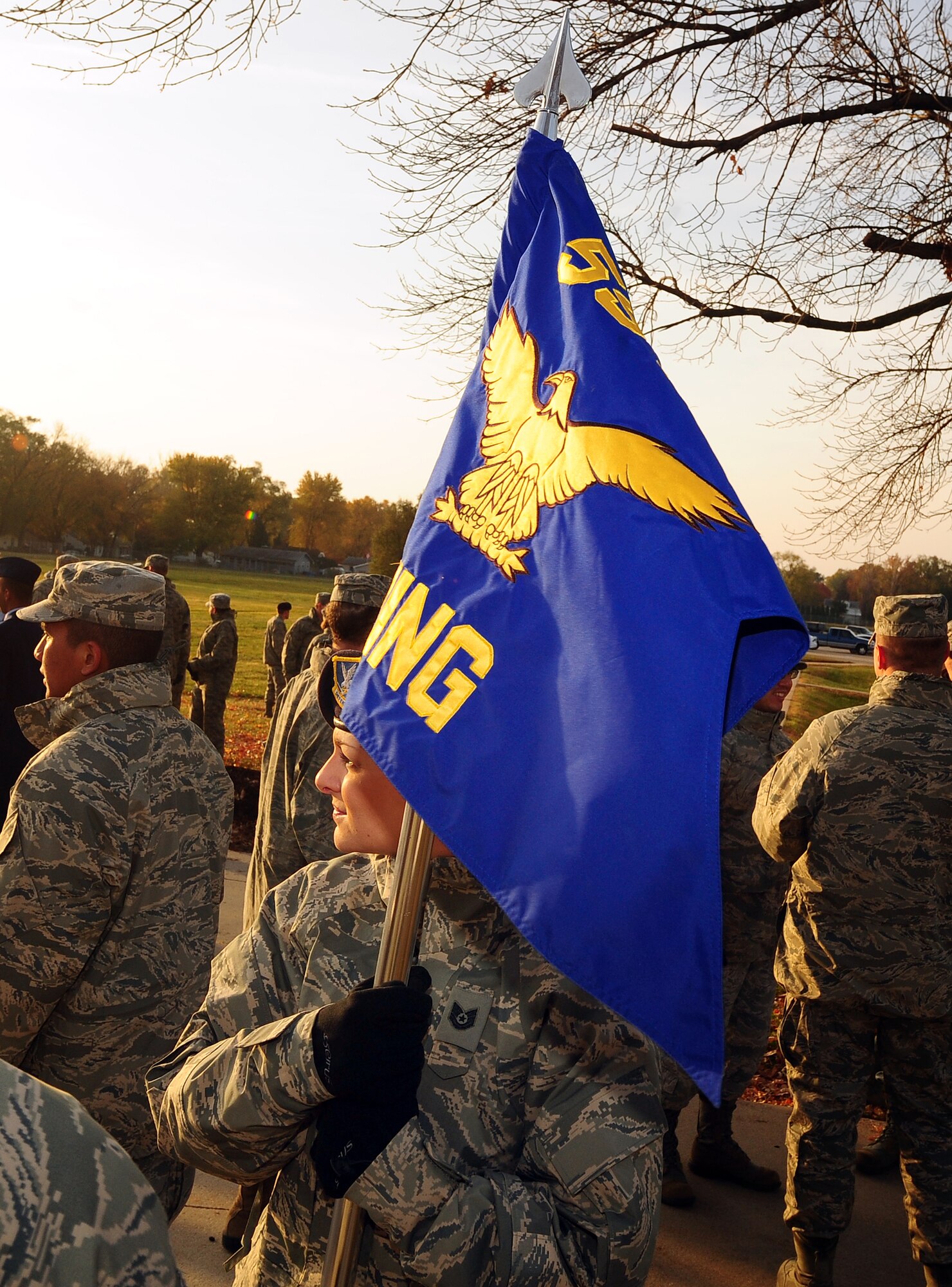 U.S. Air Force Tech. Sgt. Natasha Herbert stands ready, holding the 55th Wing guidon before marching in the 2011 Veterans Day parade held annually on Mission Avenue located in Bellevue, Neb., Nov. 5.  Along with the 55th Wing and its groups, U.S. Strategic Command and the Air Force Weather Agency units also marched in the parade. (U.S. Air Force photo by Josh Plueger/Released)