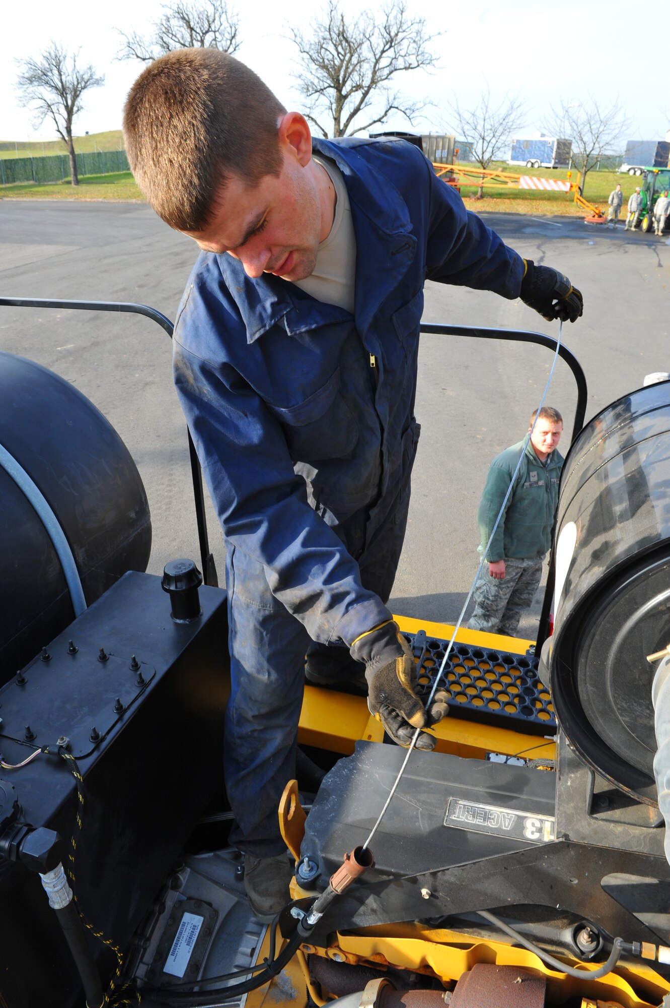 SPANGDAHLEM AIR BASE, Germany – Airman 1st Class Joseph Floyd, 52nd Civil Engineer Squadron heavy equipment operator, practices checking transmission oil on a snow plow as a part of a 360 degree check during annual snow-control augmentee training here Nov. 8. The 52nd CES snow-control team completes annual mandatory training before they can be licensed to operate and maintain snow-removal vehicles used during winter. The team assigns 33 permanent augmentees and 10 alternate augmentees from Nov. 14 to April 15 each year for the snow season. (U.S. Air Force photo/Airman 1st Class Dillon Davis)