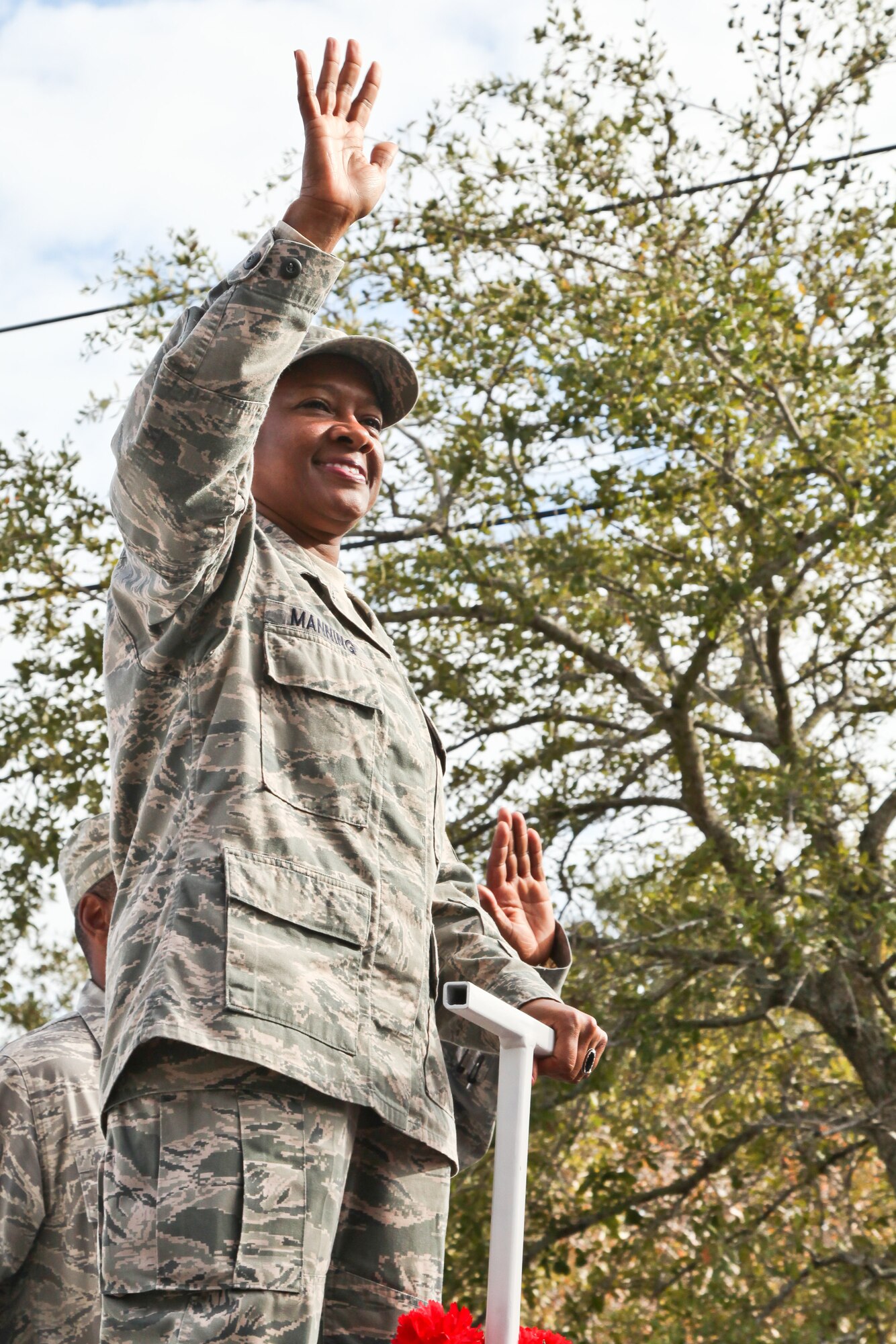 Chief Master Sergeant Gigi Manning, 315th Airlift Wing command chief, waves at onlookers during annual Charleston Veteran's Day parade.  (U.S. Photo/Staff Sgt. Rashard Coaxum)