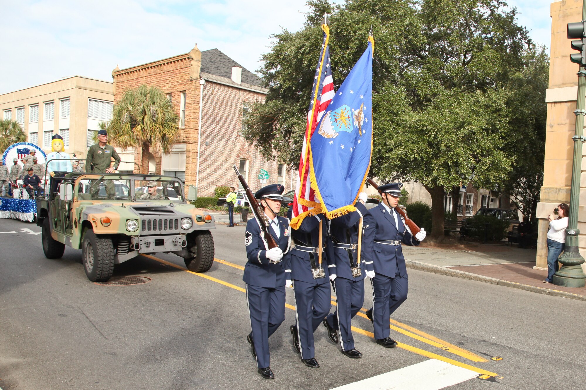 The 315th Airlift Wing Honor Guard march with the colors in front of Col. Steven Chapman during the annual Charleston Veteran's Day parade.  (U.S. Photo/Staff Sgt. Rashard Coaxum)