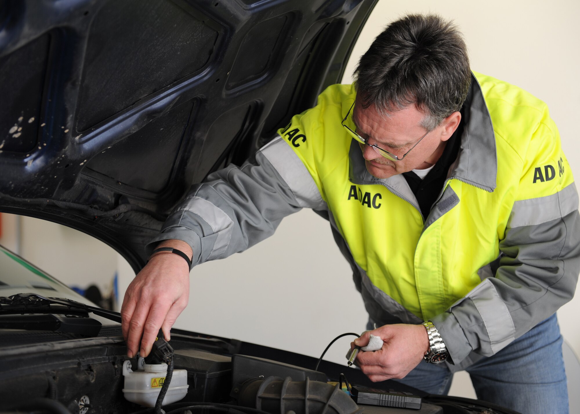 SPANGDAHLEM AIR BASE, Germany – Robert Fuss, ADAC Office of Traffic and Technology chief, checks the brake fluid on a vehicle during a winter safety inspection at the vehicle registration building here Nov. 5. The 52nd Fighter Wing Safety Office and ADAC teamed up to do a free vehicle inspection. The items checked included lights, brake fluid, battery, tires, coolant and other functions to prepare Sabers for safe winter driving. (U.S. Air Force photo/Senior Airman Christopher Toon)