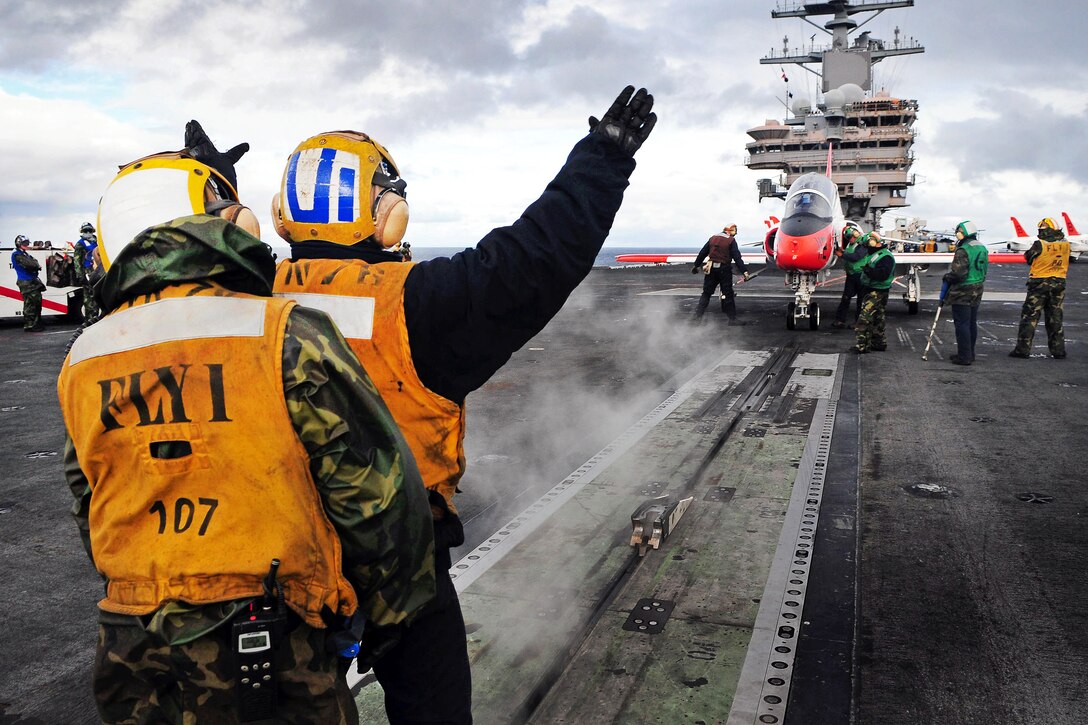 A T-45C Goshawk assigned is guided toward a catapult on the flight deck of the USS Ronald Reagan in the Pacific Ocean, Nov. 4, 2011. The Ronald Reagan is supporting Naval Air Training Command carrier qualifications.