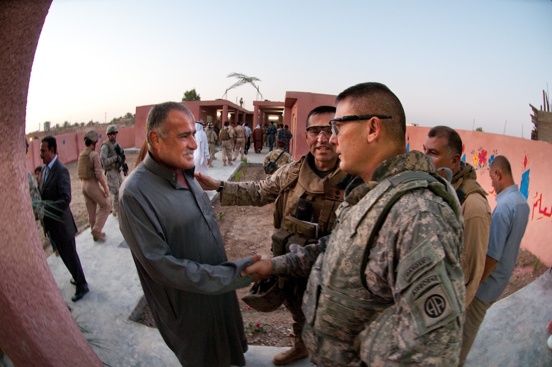 Col. Matthew Lopez, commander of Marine Regimental Combat Team 6, introduces the Karmah education inspector to Col. Mark Stammer, commander of 1st Brigade, 82nd Airborne Division (Advise and Assist Brigade), at the opening of the Karmah School for Girls, Sept. 9, 2009, Karmah, Iraq. Stammer’s brigade of paratroopers is continuing the Marine’s partnerships with Iraqi security forces, sheiks, and local and provincial officials to ensure that school and water projects begun in Karmah continue to completion. (U.S. Army photo by Spc. Michael J. MacLeod) (released)