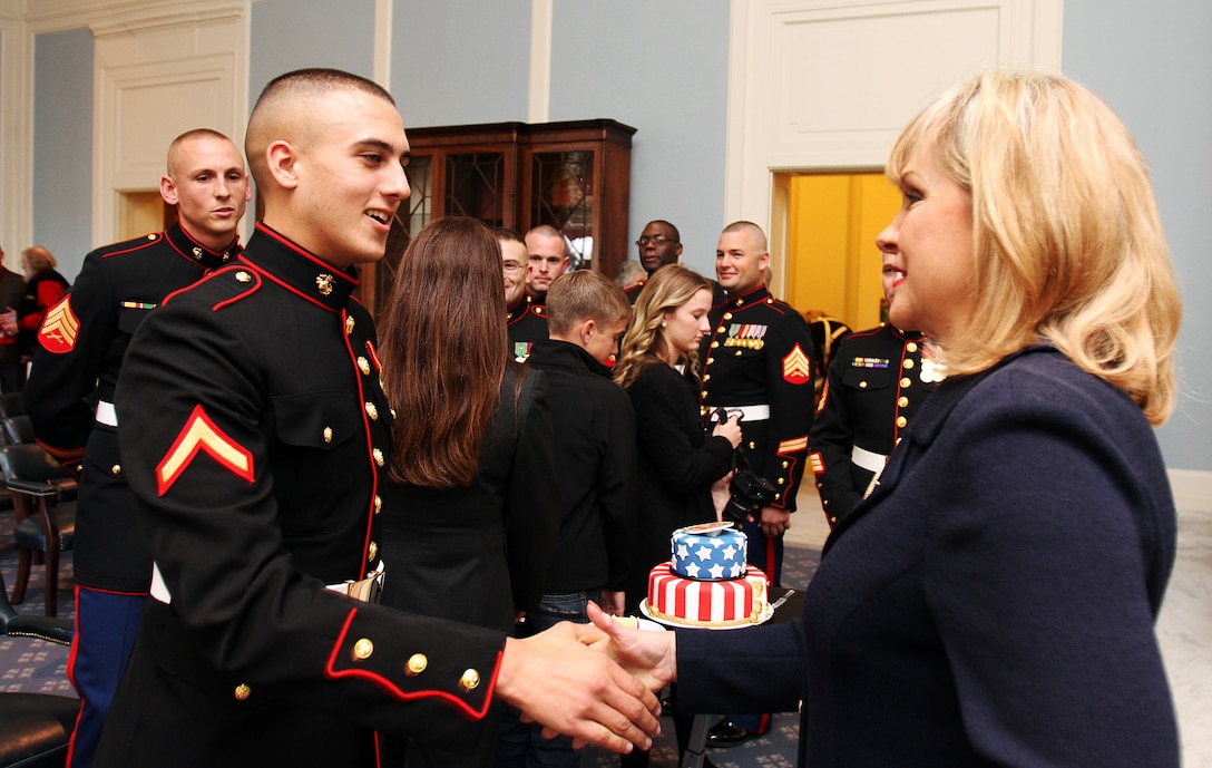 OKLAHOMA CITY - Private First Class Alex Perakis shakes hands with Oklahoma Gov. Mary Fallin during the Marine Corps birthday cake cutting ceremony where the governer proclaimed November as "Marine Month" in the state of Oklahoma, at the state capitol here, Nov. 9.::r::::n::Perakis is a graduate of Deer Creek High School in Edmond, Okla.