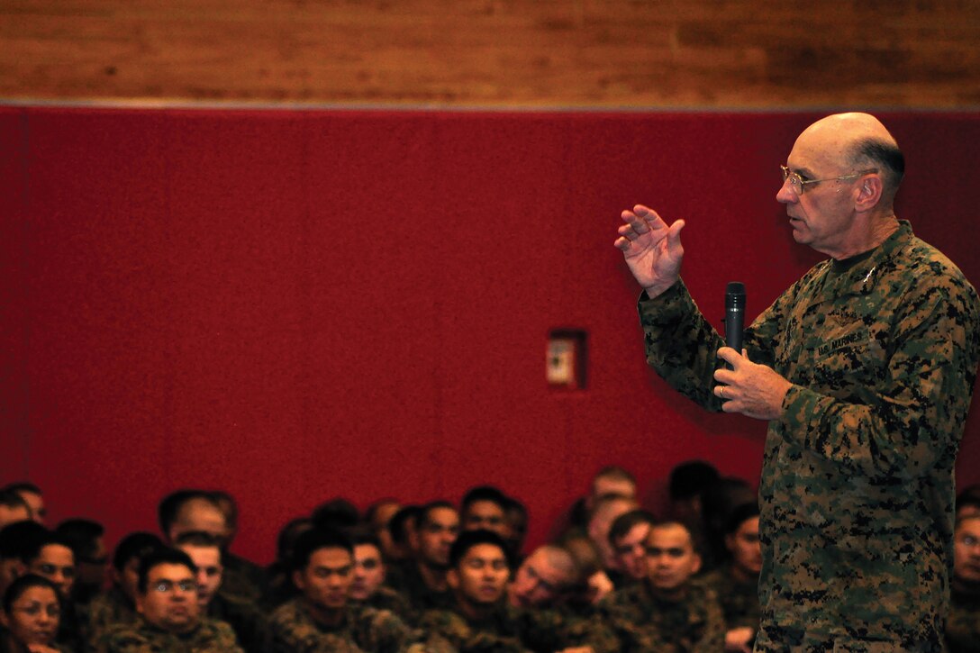 Lt. Gen. Duane D. Thiessen, commander of U.S. Marine Corps Forces, Pacific, speaks to a gym full of Marines on the House of Pain’s basketball court on Camp Hansen Nov. 9. Thiessen spoke to Marines at townhall-style meetings on several Okinawa Marine bases.