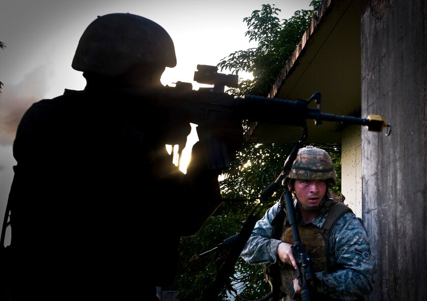 ANDERSEN AIR FORCE BASE, Guam— A fire team prepares to raid a house during training at the Pacific Air Forces Regional Training Center here, Nov. 7.  Throughout the year, the 736 SFS Commando Warrior Flight trains near one thousand Airman and joint service personnel from all around the Pacific region. (U.S. Air Force photo by Senior Airman Benjamin Wiseman/Released)