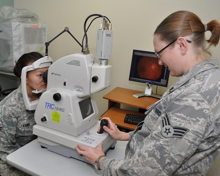 Senior Airman Kristy Overton, 9th Aerospace Medicine Squadron (AMDS) ophthalmic technician, prepares a Topcon Digital Retina Imaging System for use on Airman 1st Class Mai Yang, 9th AMDS, at the optometry clinic on Beale Air Force Base, Calif., Nov. 9, 2011.  The machine takes digital photographs of an individual's retina for examination and displays the image immediately on their computer.  (U.S. Air Force photo by Staff Sgt. Jonathan Fowler/Released)