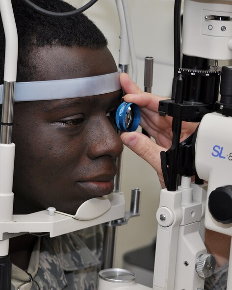 Senior Airman Brandon Brewer has his eye examined with a slit lamp microscope at the optometry clinic on Beale Air Force Base, Calif., Nov. 9, 2011.  The microscope is used to exam the structure of his eye to help determine the appropriate perscription for his eyes.  (U.S. Air Force photo by Staff Sgt. Jonathan Fowler/RELEASED)