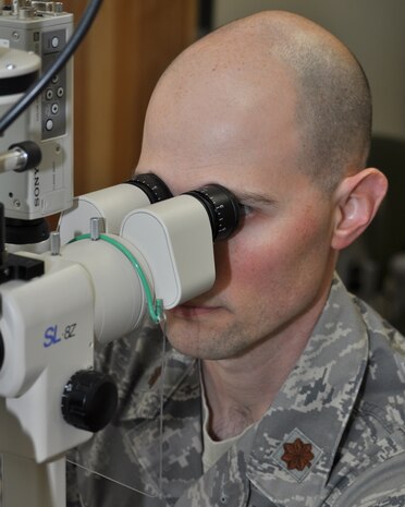 Maj. Nathan Anderson, 9th Aerospace Medicine Squadron optometry flight commander, uses a slit lamp microscope during an eye examination at the optometry clinic on Beale Air Force Base, Calif., Nov. 9, 2011.  Anderson uses the microscope to exam the structure of an Airman's eye.  (U.S. Air Force photo by Staff Sgt. Jonathan Fowler/Released)