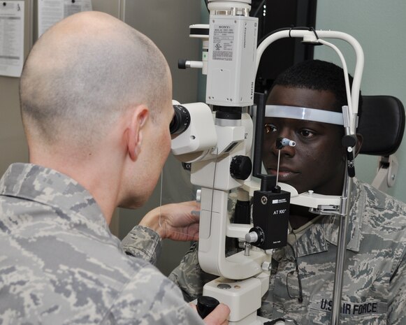 Maj. Nathan Anderson, 9th Aerospace Medicine Squadron optometry flight commander, uses a slit lamp microscope on Senior Airman Brandon Brewer during an eye examination at the optometry clinic on Beale Air Force Base, Calif., Nov. 9, 2011.  Major Anderson uses the microscope to exam the structure of an Airman's eye.  (U.S. Air Force photo by Staff Sgt. Jonathan Fowler/Released)