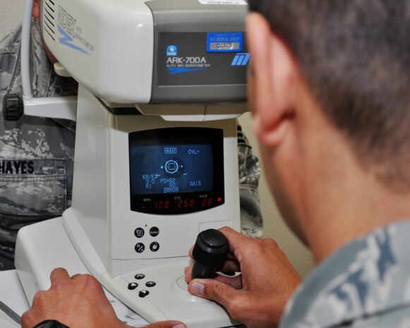 Master Sgt. Jose Diaz, 9th Aerospace Medicine Squadron optometry flight chief, uses an auto refracter on Senior Airman Robert Hayes during an eye exam at the optometry clinic on Beale Air Force Base, Calif., Nov. 9, 2011.  The machine is used to help determine a patients perscription and is one of many instruments used to determine the quality of an individuals eyesight.  (U.S. Air Force photo by Staff Sgt. Jonathan Fowler/Released)
