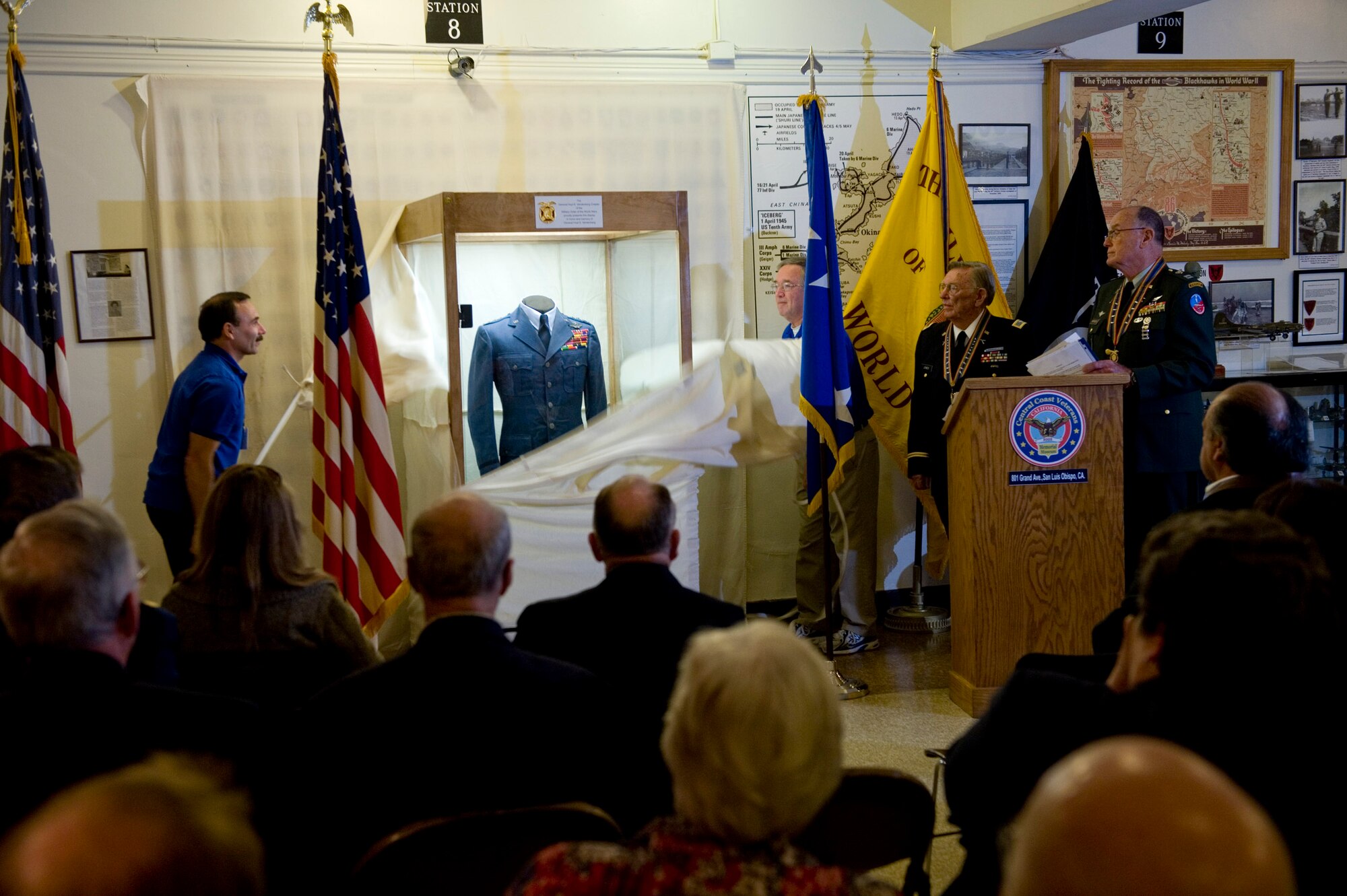 VANDENBERG AIR FORCE BASE, Calif. - Museum staff members unveil the new Gen. Hoyt S. Vandenberg display at the Central Coast Veterans Memorial Museum in San Luis Obispo, Calif., Tuesday, Nov. 8, 2011. Maj. Gen. Hoyt S. Vandenberg Jr. donated his father's uniform items to the Vandenberg chapter of the Military Order of World War who then loaned the items to the museum for permanent display. Gen. Vandenberg was the Air Force's second Chief of Staff, is known for officially authorizing the Air Force's blue service dress and has Vandenberg Air Force Base named after him. (U.S. Air Force/Staff Sgt. Levi Riendeau)
