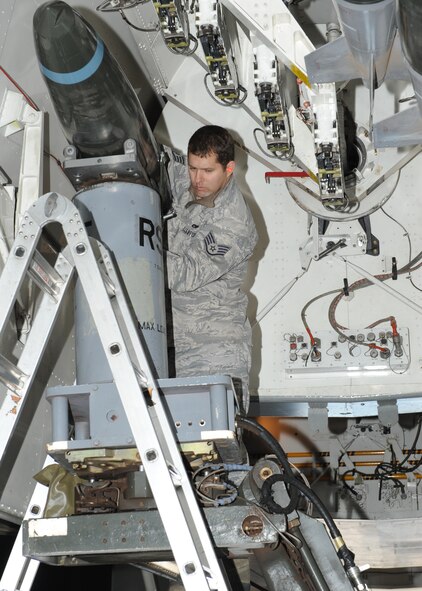 Staff Sgt. Timothy Sevigny, 7th Aircraft Maintenance Squadron, positions a Mark-82 Nov. 9, 2011 during a proficiency load exercise at Dyess Air Force Base, Texas. Exercises are conducted monthly to keep airmen qualified to load different munitions. (U.S. Air Force photo by Airman 1st Class Jonathan Stefanko/Released)