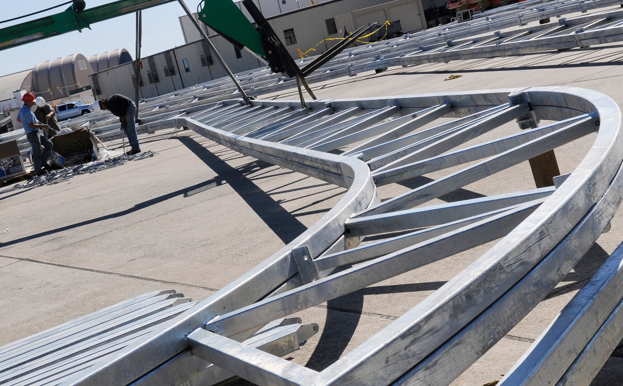Workmen prepare steel trusses for the new C-130 shelters on the flightline Nov 2. U. S. Air Force photo by Sue Sapp