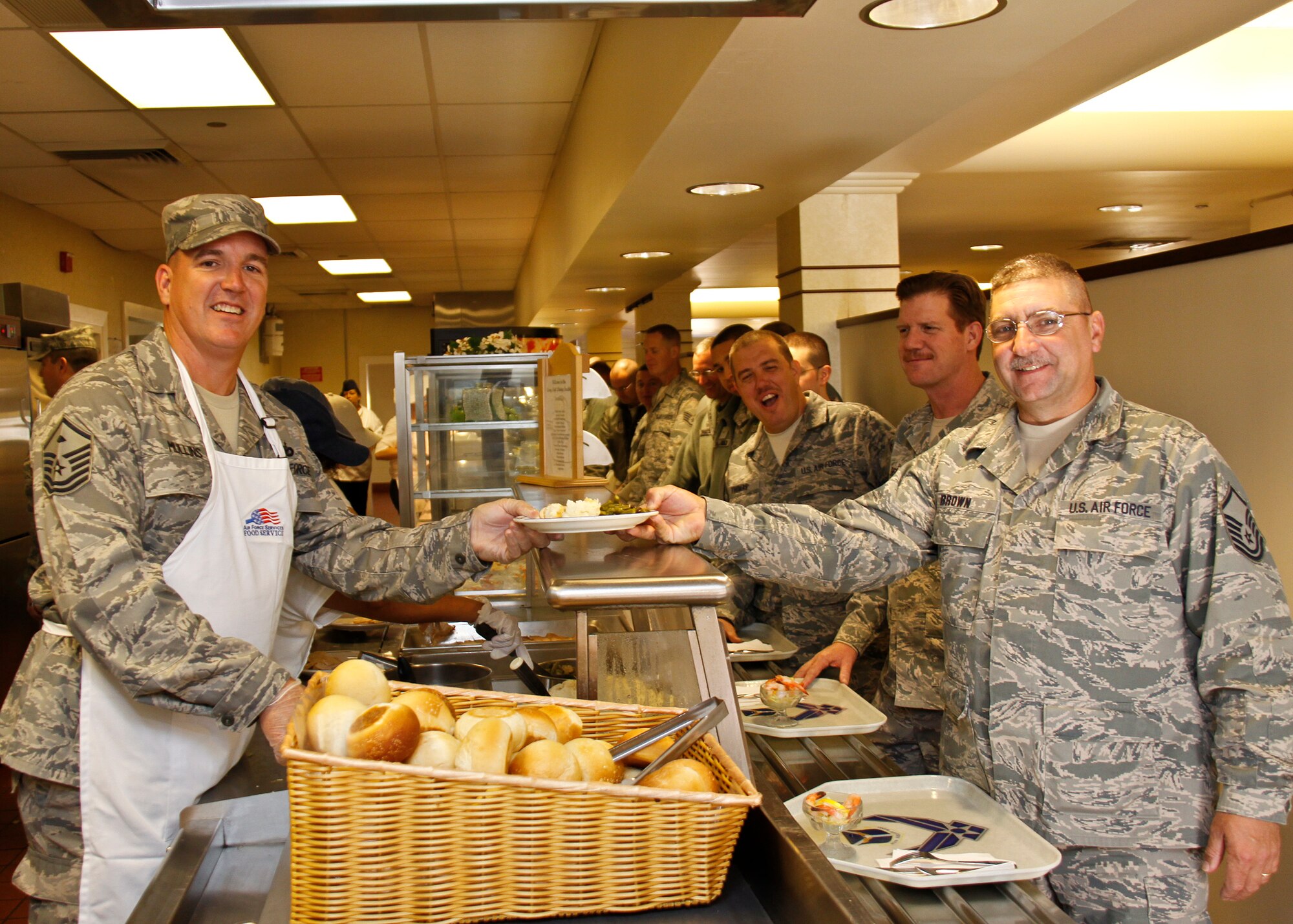 PITTSBURGH IAP ARS, PA -- Master Sgt. Ercel Mullins, 911th Aeromedical Staging Squadron first sergeant, hands a plate of food to Master Sgt. Jason Brown, 911th Airlift Wing noncommissioned officer in-charge of equal opportunity, Nov. 5. As a way to thank 911 AW Airmen, first sergeants served lunch to them during the November Unit Training Assembly. (U.S. Air Force photo/Senior Airman Joshua J. Seybert)
