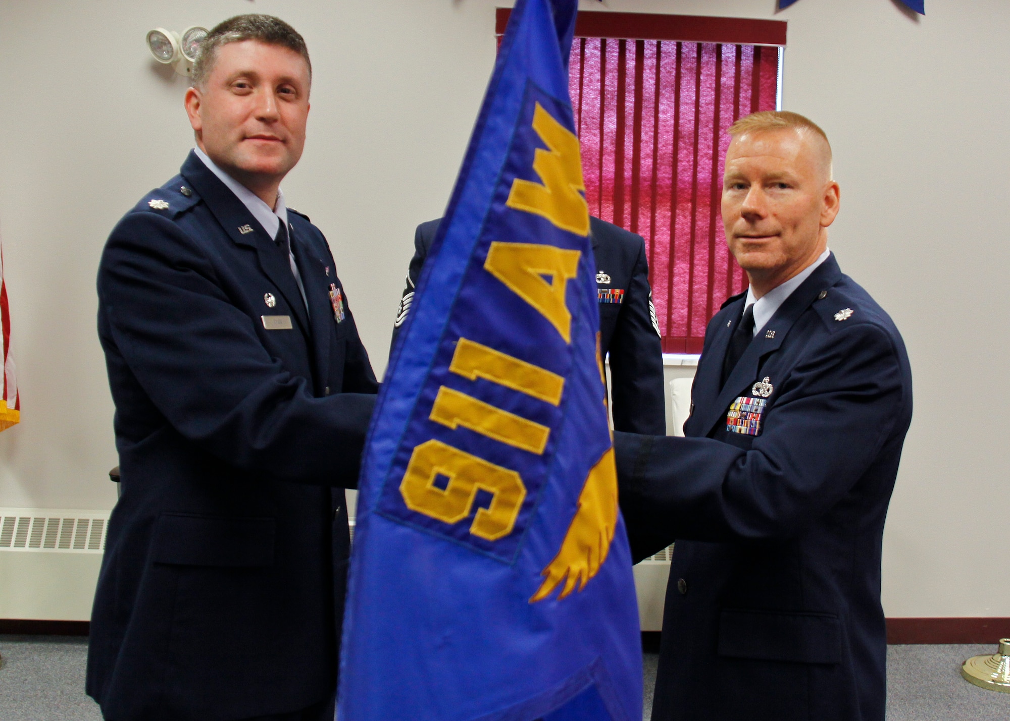 PITTSBURGH IAP ARS, PA -- (Right) Lt. Col. Darel L. Longyear, 32nd Aerial Port Squadron incoming commander, recieves the guidon from Lt. Col. Patrick Ryan, 911th Mission Support Group commander, during a Change of Command. By recieving the guidon, Colonel Longyear assumes command of the 32nd APS. (U.S. Air Force photo/Senior Airman Joshua J. Seybert)