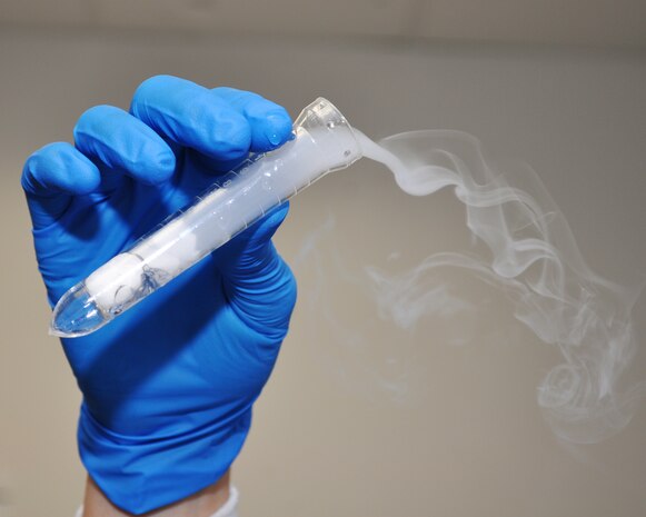 U.S. Air Force Staff Sgt. Jennifer Johnson, 9th Medical Support Squadron laboratory technician, holds a speciman with dry ice at the medical laboratory on Beale Air Force Base, Calif., Nov. 9, 2011.  The laboratory uses dry ice to keep specimans and samples frozen during shipping.  (U.S. Air Force photo by Staff Sgt. Jonathan Fowler)