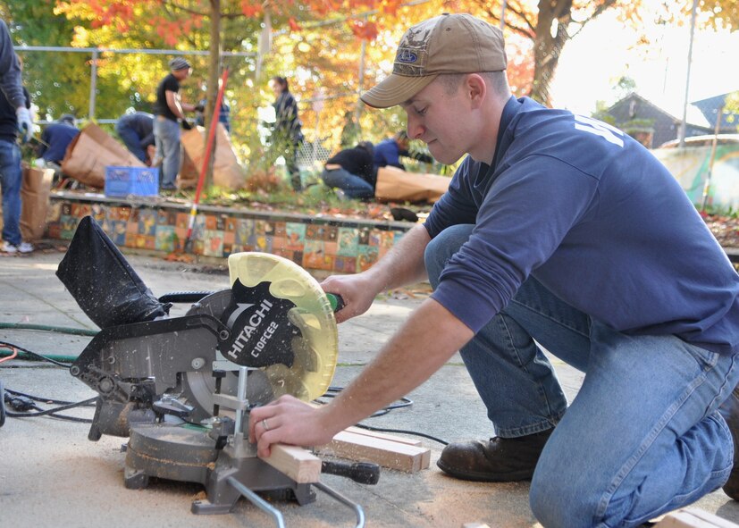 Staff Sgt. Steven Seibert, 627th Civil Engineering Squadron, cuts wood to build new flower boxes at Madrona School Nov. 5, 2011, in Seattle. “As a military member, often times we receive a lot of appreciation,” said Seibert. “Giving back to our local community is a high priority.” (U.S. Air Force photo/Airman 1st Class Leah Young)