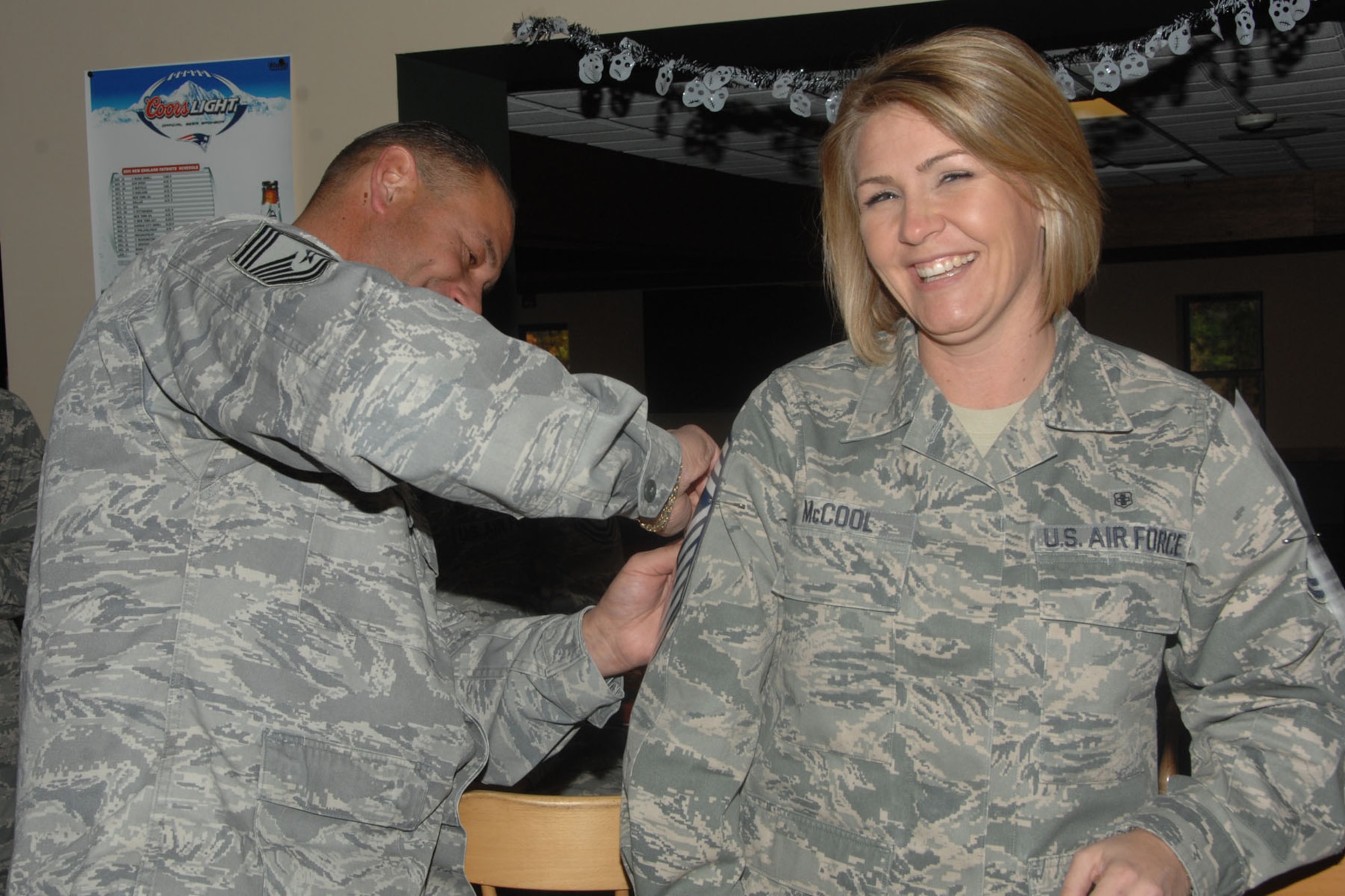 HANSCOM AIR FORCE BASE, Mass. – Newly selected Chief Master Sgt. Kathleen McCool, from the 319th Recruiting Squadron, gets her stripes pinned on by Chief Master Sgt. Alfred Wilkes, 319th Recruiting Squadron superintendent, during the 2011 Chief Master Sergeant Promotion Release Celebration at the Minuteman Commons Nov. 3. (U.S. Air Force photo by Linda LaBonte Britt) 