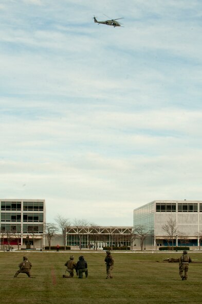 Members of the 58th Rescue Squadron out of Nellis Air Force Base, Nev. a geographically separated unit (GSU) of the 23d Wing at Moody Air Force Base, Ga., secure the area while rescuing downed personnel as an HH-60G Pave Hawk from the 66th Rescue Squadron, also a GSU to Moody from Nellis, provides top cover during a personnel recovery demonstration for the U.S. Air Force Academy in Colorado Springs, Colo., Nov. 4, 2011. The demonstration showcased the 23rd Wing’s rescue capability to the cadets and was used as a motivational tool for the Air Force football game against the U.S. Army scheduled for the following day. (U.S. Air Force photo by Staff Sgt. Joshua J. Garcia/Released) 
