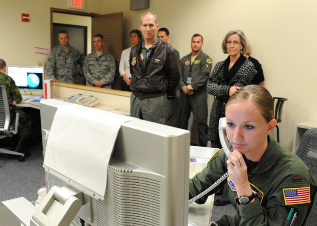 Commander of Air Combat Command, Gen. Mike Hostage, and his wife, Kathy, look on as 2nd Lt. Suzanne Sparks, 7th Space Warning Squadron crew commander, demonstrates a mock missile detection sequence in the Missile Warning Operations Center at Beale Air Force Base, Calif., Nov. 6, 2011.  7th SWS operates 24/7 and Airmen are responsible for up channeling an event analysis to the Missile Warning Center at Cheyenne Mountain in Colorado Springs, Colo., within 60 seconds of the initial detection. (U.S. Air Force photo by Mr. John Schwab/Released)