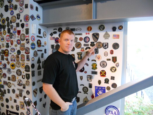 While visiting Paul Jr. Designs in Rock Tavern, N.Y., U.S. Air Force Staff Sgt. Patrick Mackey, 366th Logistics Readiness Squadron quality assurance inspector, points at a unit patch Sept. 27, 2011. Mackey was invited to Paul Jr. Designs after presenting the reality television star and custom motorcycle designer Paul Jr. Teutal with an American flag flown at 14 locations throughout Iraq. (Courtesy photo) 

