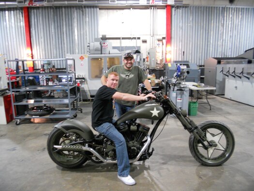 U.S. Air Force Staff Sgt. Patrick Mackey, 366th Logistics Readiness Squadron quality assurance inspector, sits on the Jared Allen bike while posing with Paul Jr. Teutal of Paul Jr. Designs and star of American Chopper: Sr. vs. Jr., Sept 26, 2011, at Paul Jr. Designs in Rock Tavern, N.Y. Mackey presented Paul Jr. with an American flag he flew at 14 locations throughout Iraq while performing convoy missions. (Courtesy photo) 

