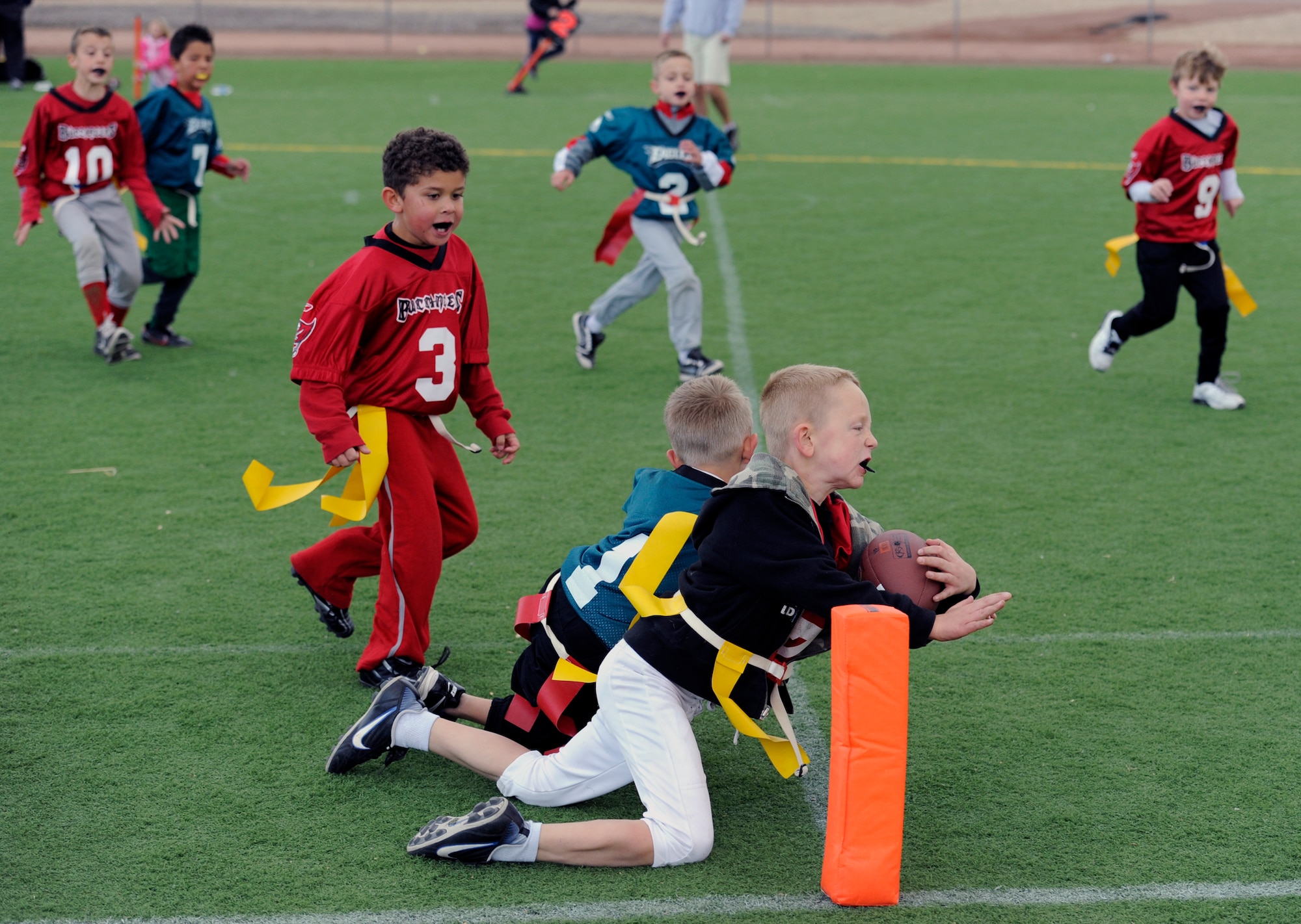 HOLLOMAN AIR FORCE BASE, N.M. -- Joey Cox, son of U.S. Air Force Tech. Sgt. Jonathon Cox, 49th Maintenance Operations Squadron, scores a touchdown Oct. 22, 2011, during a game at Johnson Field. The Holloman Youth Sports Program currently offers soccer, flag football, basketball, t-ball, coach-pitch baseball and cheerleading, and in the future will be implementing volleyball and a running program. (U.S. Air Force photo by Airman 1st Class Siuta B. Ika/Released)