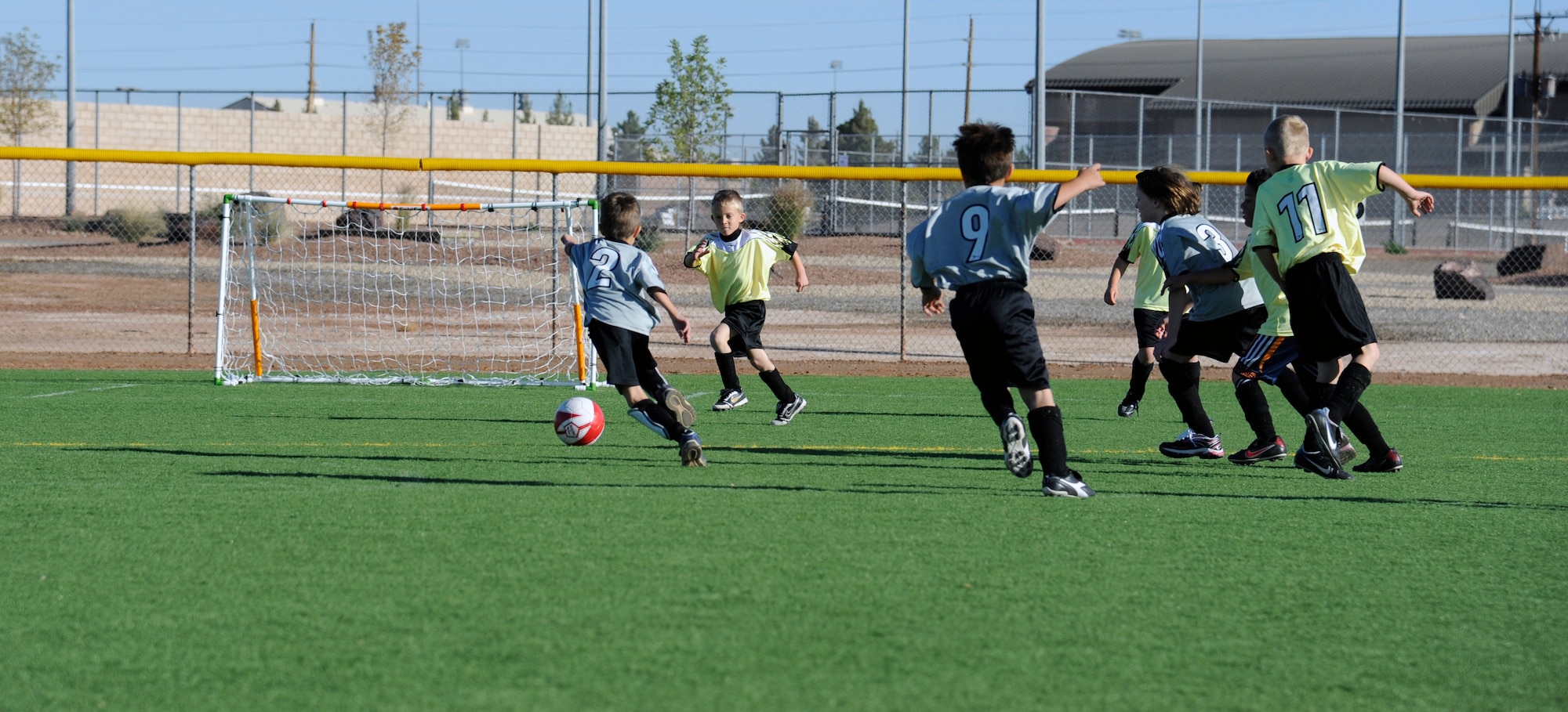 HOLLOMAN AIR FORCE BASE, N.M. -- Children in Holloman’s Youth Soccer League go after a ball Oct. 22, 2011, during a game at Johnson Field. Although the soccer league is only available to children five to twelve years old, the Holloman Youth Sports Program offers an instructional program that focuses on fundamentals of the sport for children three to five years old. (U.S. Air Force photo by Airman 1st Class Siuta B. Ika/Released)