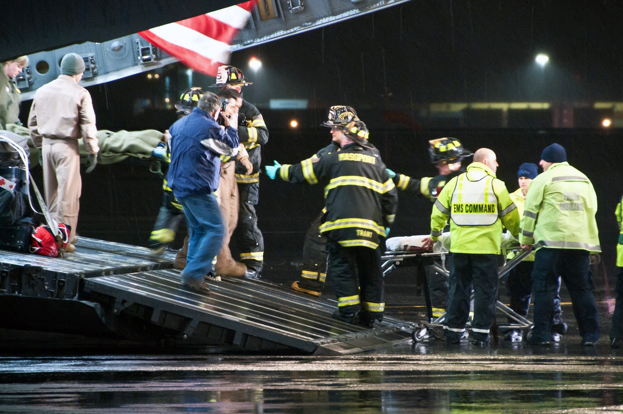 Air Force aeromedical evacuation crews, along with local emergency medical personnel, assist Libyan fighters off a C-17 Globemaster III military transport aircraft Oct. 29, 2011, at Boston Logan Airport, Mass. At the request of the Department of State and directed by the Secretary of Defense Leon Panetta, Air Force and Air National Guard crews transported 22 wounded Libyans to Spaulding Rehabilitation Hospital in Salem, Mass. (U.S. Air Force photo by Walter Santos) (Released)
