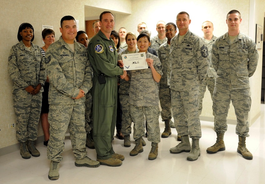 LAUGHLIN AIR FORCE BASE, Texas – Senior Airman Xanthe Pajarillo, 47th Medical Support Squadron referral management technician, poses with Col. Thomas Murphy, 47th Flying Training Wing commander, after being presented the XLer of the week award here Nov. 2. The XLer is a weekly award chosen by wing leadership and given to those who consistently make outstanding contributions to Laughlin and their unit. (U.S. Air Force photo/Airman 1st Class Nathan L. Maysonet)