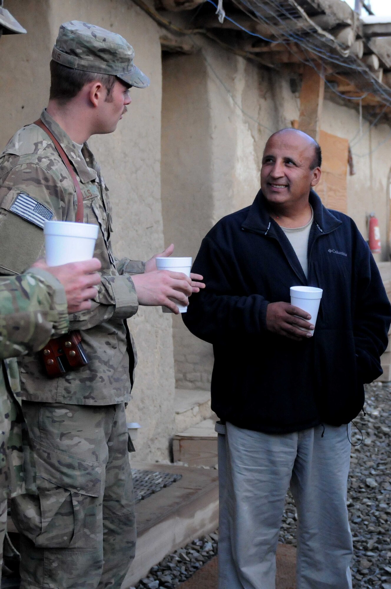 1st Lt. Ryan Mills, Provincial Reconstruction Team Paktya intelligence officer from Chicago, shares a cup of tea with Assadullah Fazily, Afghan PRT Paktya cultural advisor, born in Kabul, at Forward Operating Base Gardez, Paktya Province, Afghanistan, Nov. 8, 2011. Advisors and linguists help Soldiers and Airmen to gain a better understanding of local traditions, customs and considerations. (U.S. Air Force photo/1st Lt. Cammie Quinn)